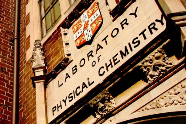 Sign reading 'Laboratory of Physical Chemistry' on a brick building wall.
