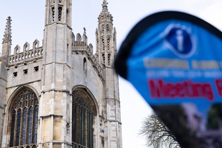 Gothic cathedral with a blurred blue sign in the foreground.