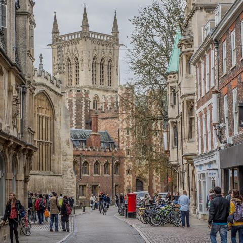 a group of people walking down a street in front of a building