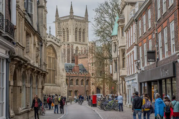 a group of people walking down a street in front of a building