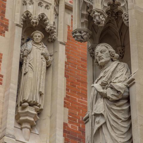 a person standing in front of a brick building