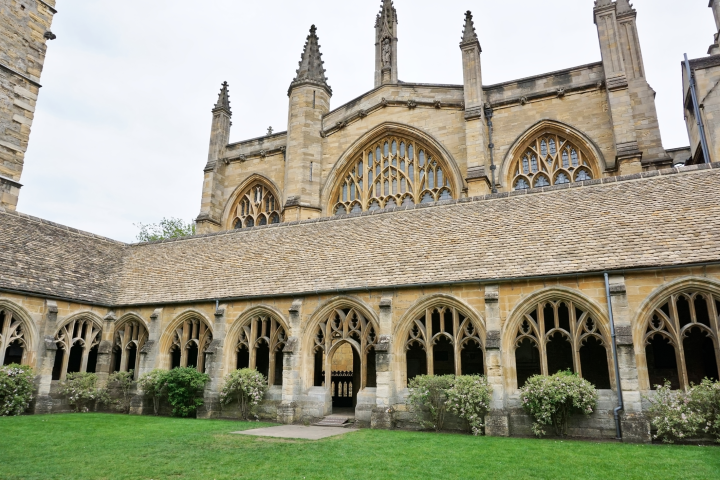 a large stone building with grass in front of a church