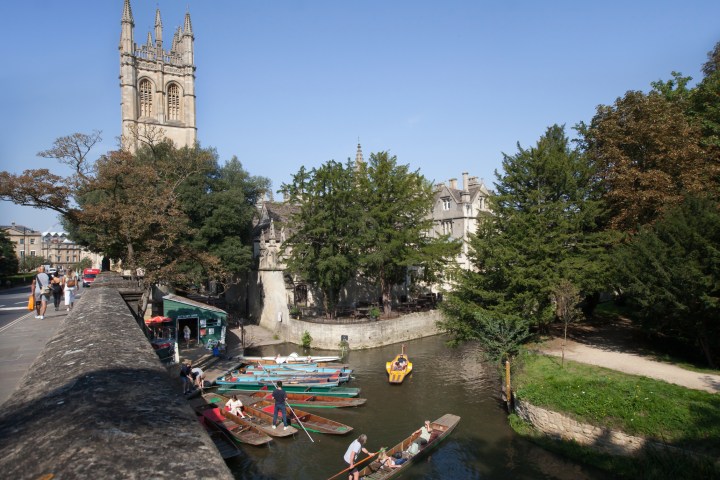 a man riding a skateboard up the side of a river